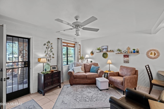 living area featuring light tile patterned floors and ceiling fan