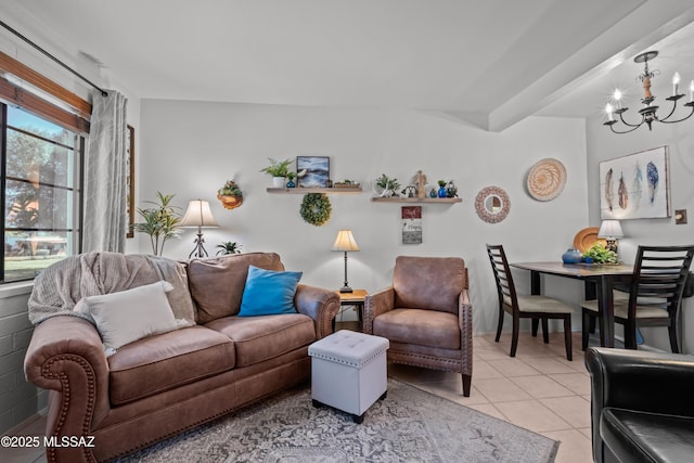 living area with light tile patterned flooring and a notable chandelier