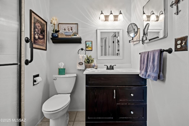 bathroom featuring vanity, tile patterned floors, toilet, and baseboards