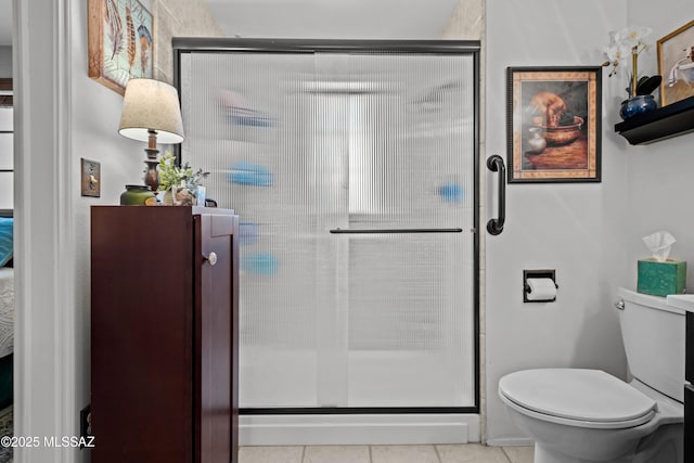 bathroom featuring tile patterned floors, a stall shower, and toilet