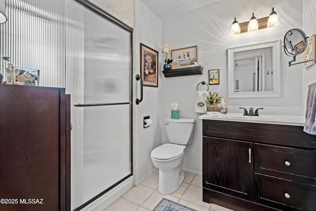 bathroom featuring toilet, a shower stall, tile patterned flooring, baseboards, and vanity