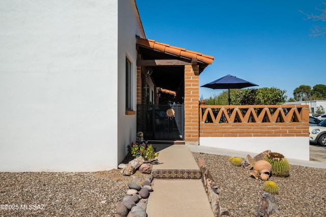 view of side of home with stucco siding