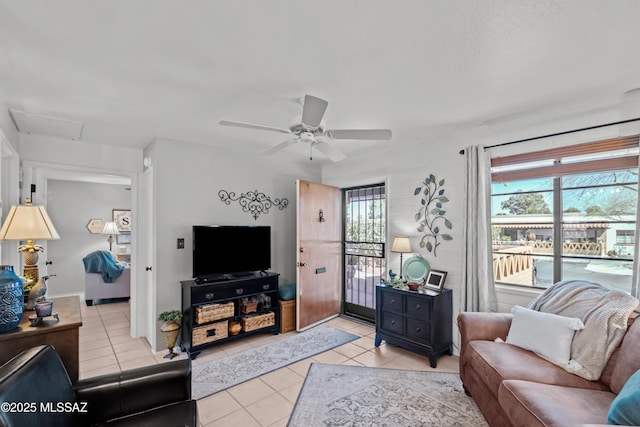 living room with ceiling fan and light tile patterned flooring