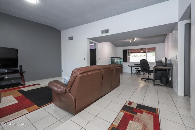 living room with light tile patterned floors, visible vents, and vaulted ceiling