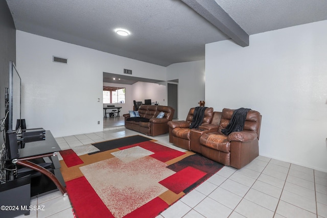 living area featuring tile patterned flooring, beam ceiling, visible vents, and a textured ceiling