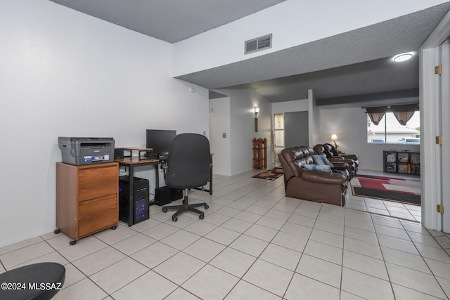 home office with visible vents, a textured ceiling, and light tile patterned flooring