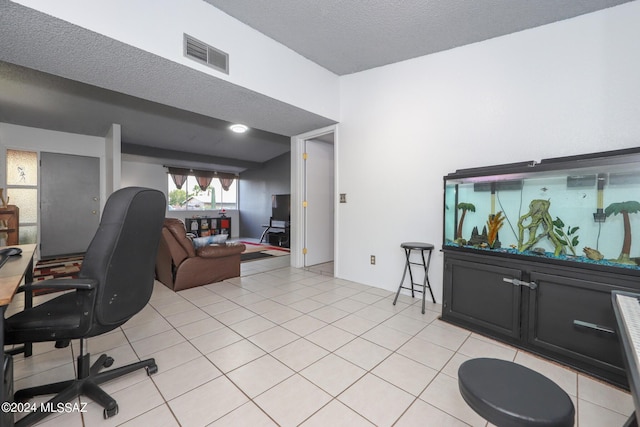 office area featuring light tile patterned floors, a textured ceiling, and visible vents