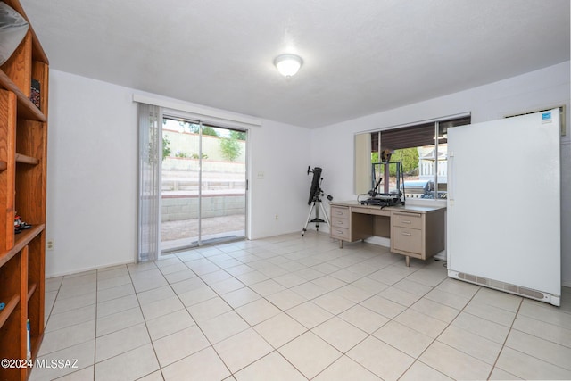 unfurnished office featuring light tile patterned floors