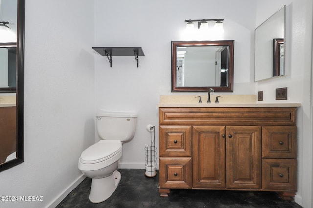 bathroom with toilet, baseboards, and vanity