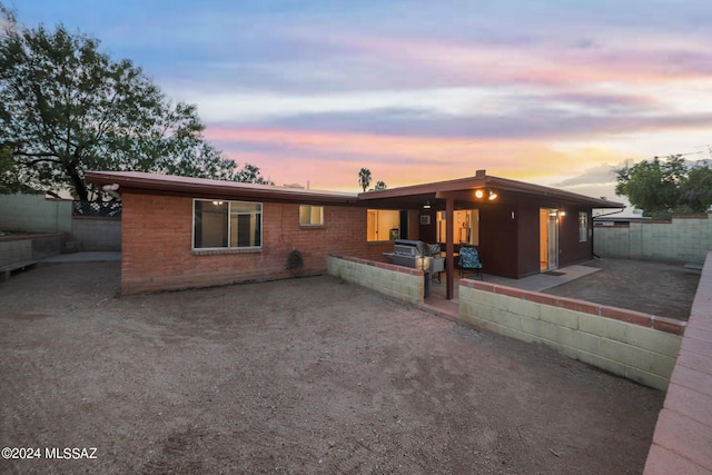 view of front of house featuring a patio area and fence