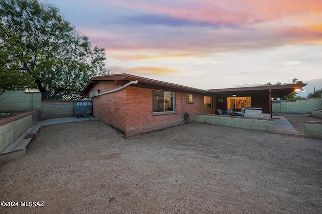 exterior space with a patio, brick siding, and a fenced backyard