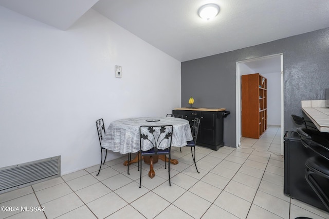 dining area with light tile patterned floors and visible vents