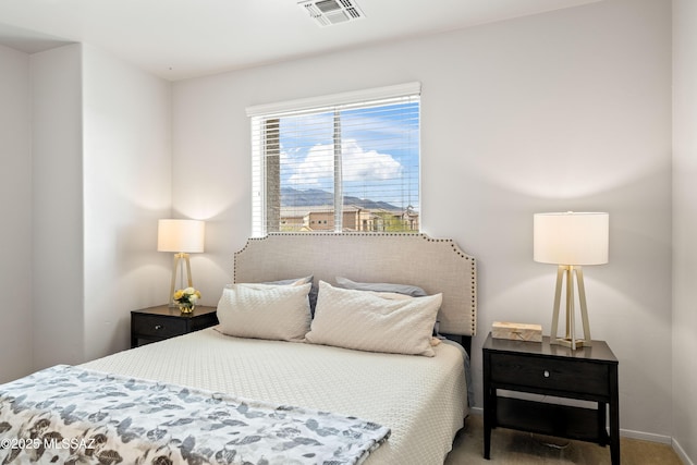 carpeted bedroom featuring visible vents and baseboards