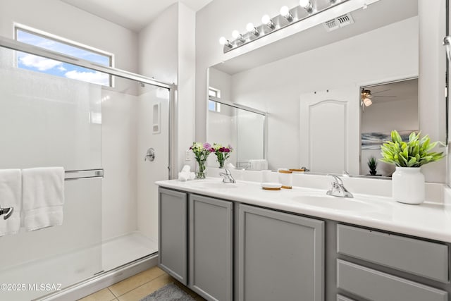 bathroom with a sink, visible vents, a shower stall, tile patterned floors, and double vanity