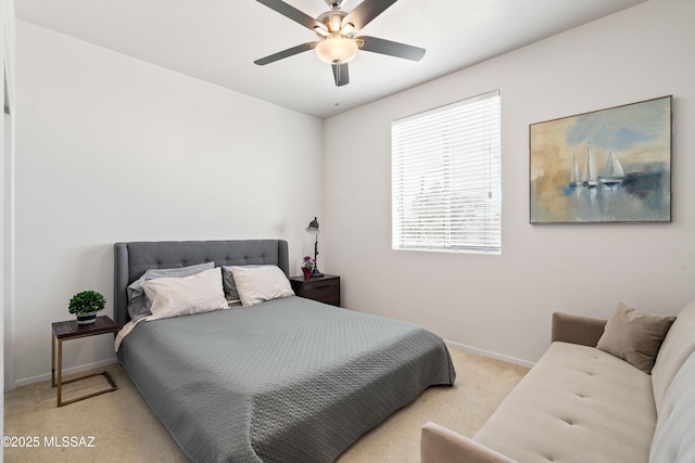 carpeted bedroom with a ceiling fan and baseboards