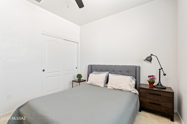 bedroom with baseboards, a closet, a ceiling fan, and carpet flooring