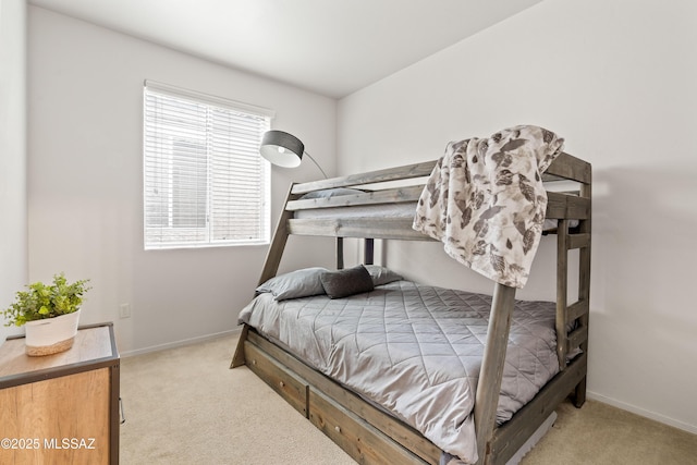 carpeted bedroom featuring baseboards