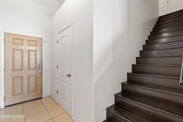 stairway featuring tile patterned flooring