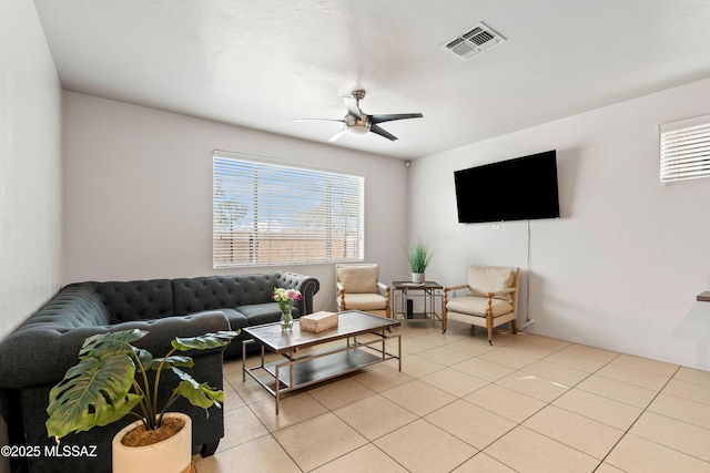 living room featuring ceiling fan, visible vents, and light tile patterned flooring