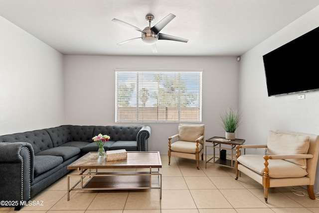 living room featuring light tile patterned floors, a ceiling fan, and baseboards