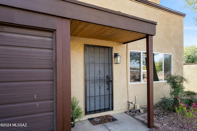 entrance to property with stucco siding