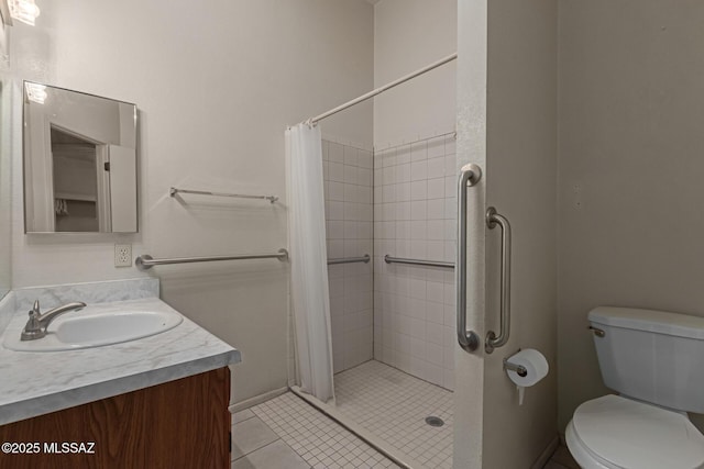 bathroom featuring vanity, tile patterned flooring, a shower stall, and toilet