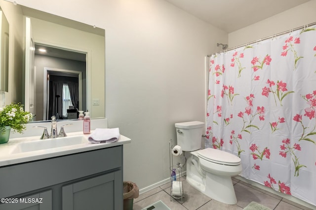 bathroom featuring vanity, a shower with shower curtain, baseboards, tile patterned flooring, and toilet