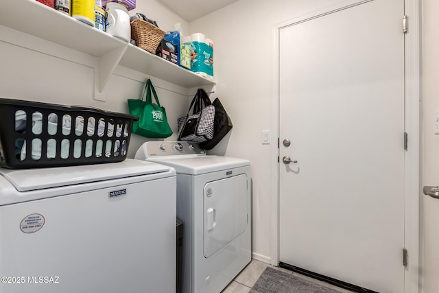 laundry area featuring light tile patterned floors, laundry area, and separate washer and dryer