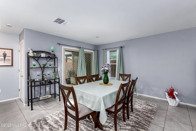 dining area with visible vents, baseboards, and tile patterned flooring