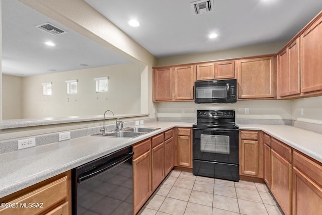 kitchen with light tile patterned floors, light countertops, visible vents, a sink, and black appliances