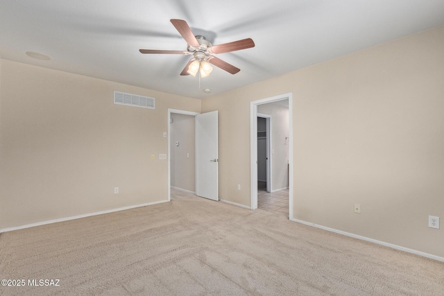 unfurnished bedroom featuring light carpet, a ceiling fan, visible vents, and baseboards