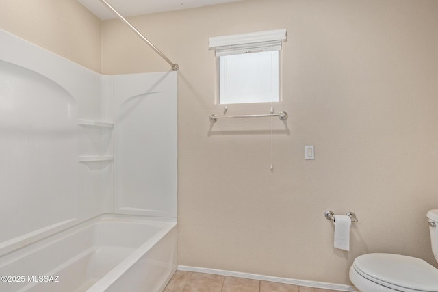 bathroom with tub / shower combination, toilet, and baseboards