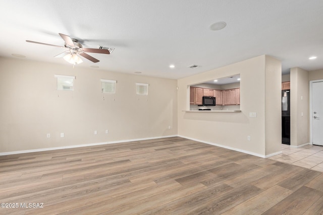 unfurnished living room with light wood finished floors, baseboards, visible vents, ceiling fan, and recessed lighting