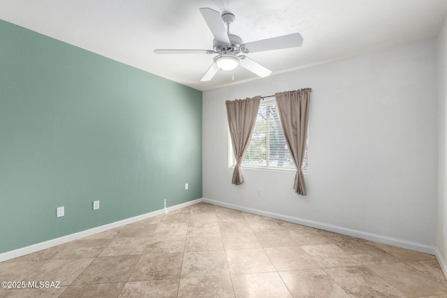 empty room with baseboards, a ceiling fan, and tile patterned floors