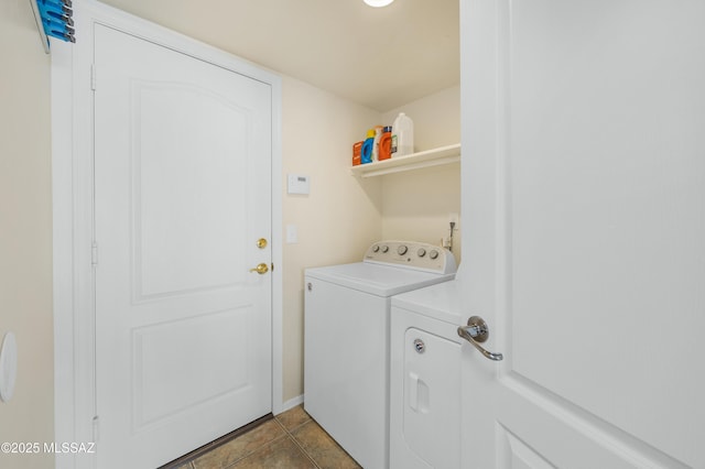 clothes washing area featuring laundry area, dark tile patterned floors, and independent washer and dryer