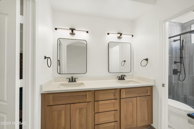 full bathroom featuring a sink, a stall shower, and double vanity