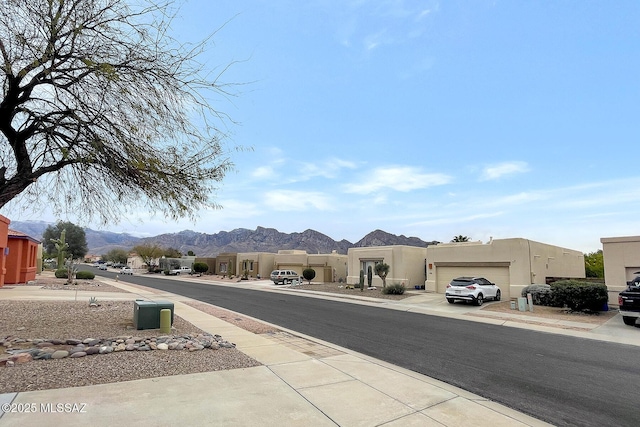 view of road featuring a mountain view and sidewalks