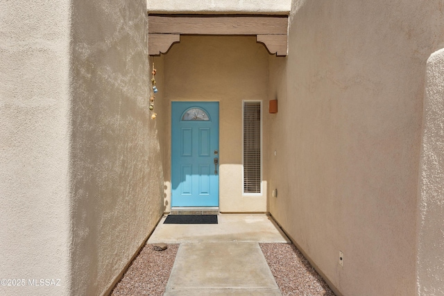 property entrance featuring stucco siding