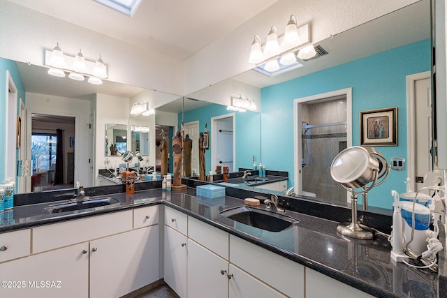 bathroom with a stall shower and vanity