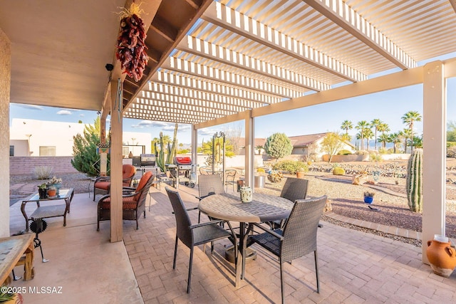 view of patio with outdoor dining area, fence, and a pergola