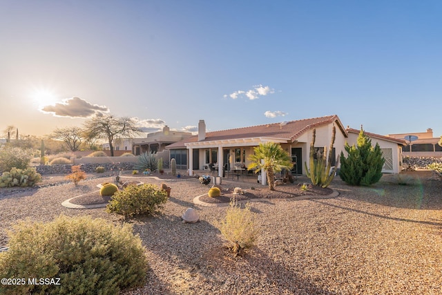 back of house featuring a patio area and stucco siding