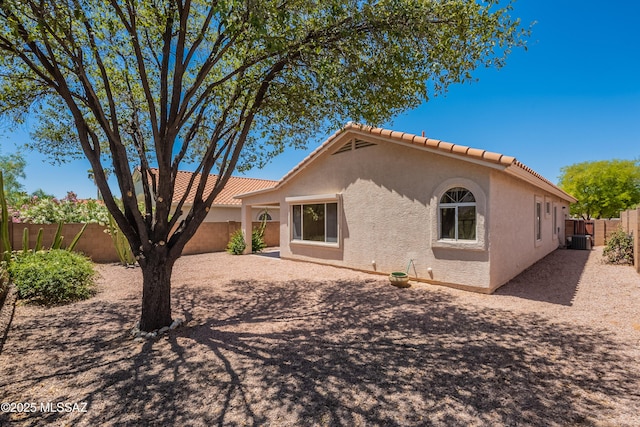 12220 N New Dawn Ave, Oro Valley, AZ 85755 - back of house featuring central air condition unit, stucco siding, a fenced backyard, and a tile roof