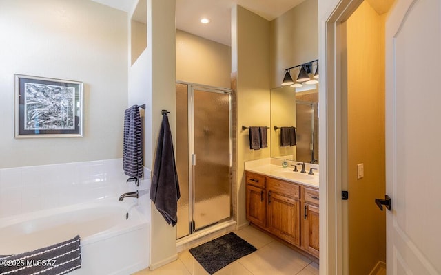 bathroom with a garden tub, recessed lighting, a shower stall, vanity, and tile patterned flooring