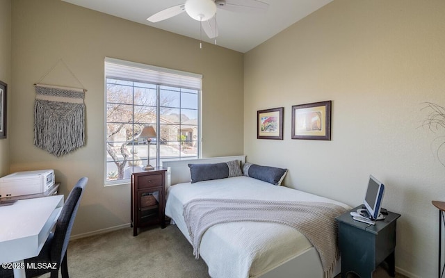 bedroom with light carpet, multiple windows, baseboards, and a ceiling fan