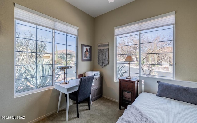 carpeted bedroom featuring baseboards