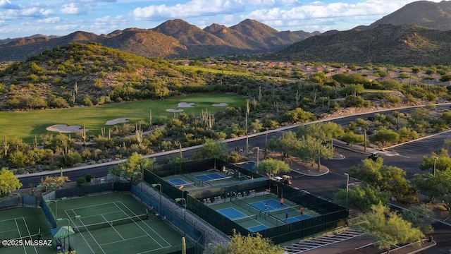 drone / aerial view with golf course view and a mountain view