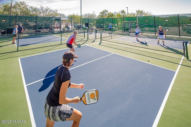 view of tennis court with fence