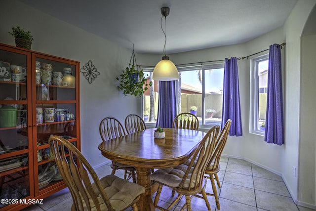 dining area featuring baseboards and light tile patterned flooring