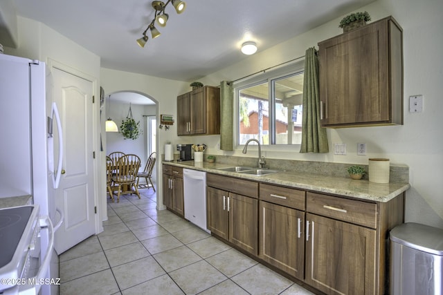 kitchen with arched walkways, a sink, range with electric cooktop, white dishwasher, and light tile patterned floors