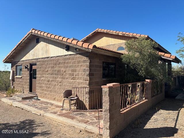 view of side of property featuring concrete block siding